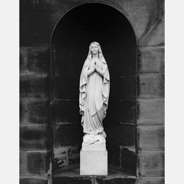 Statue of Woman With Crucifix Thumbnail